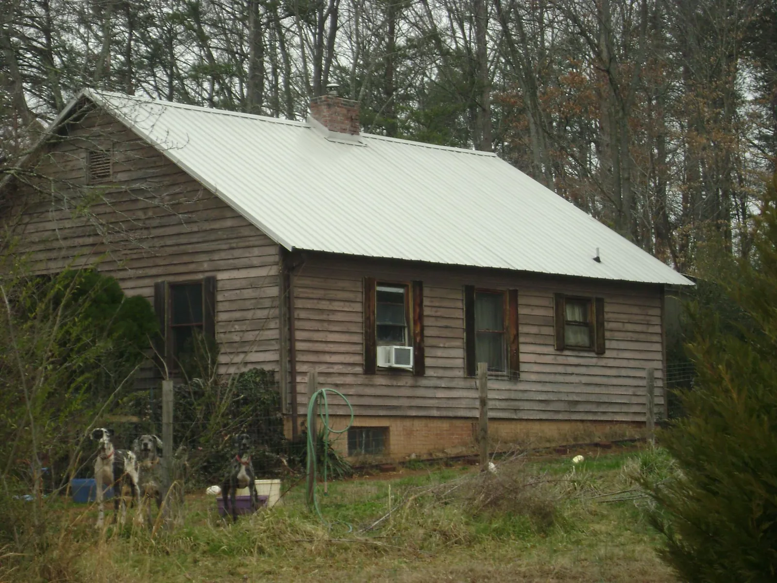 White metal roof on an old wood sided farmhouse, from a Metal Roof Installation job in New Florence